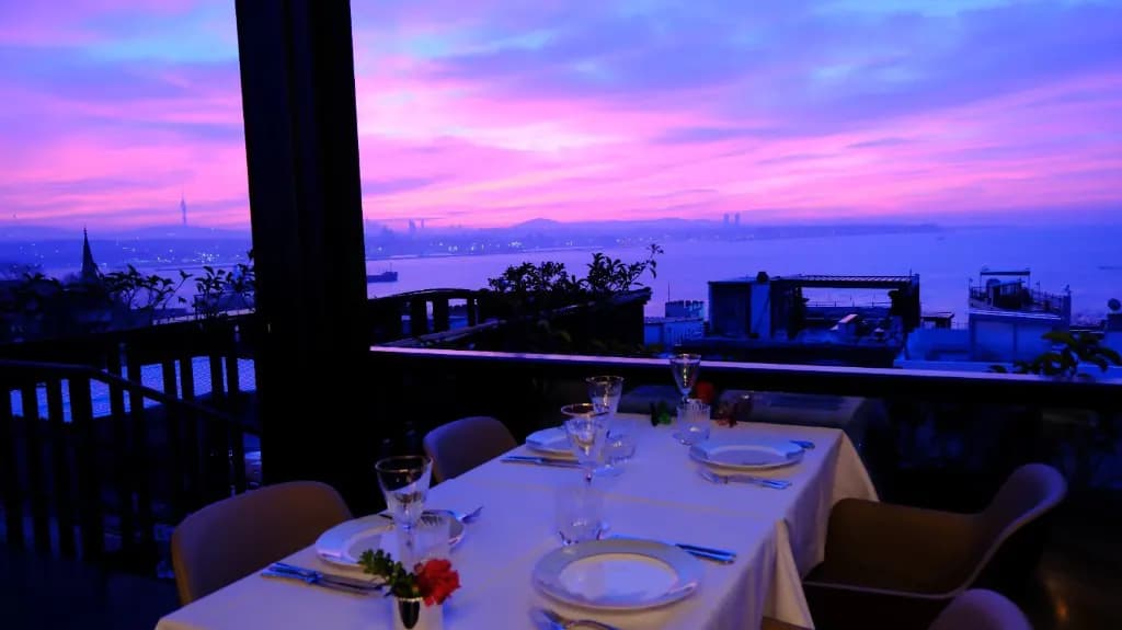 Gün batımında AYA Roof Lounge terasında iki kişilik teklif masası